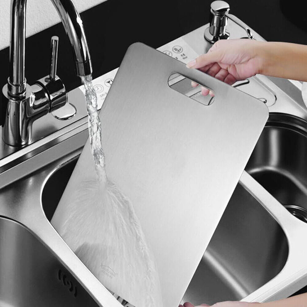 Reversible stainless steel cutting board for food preparation