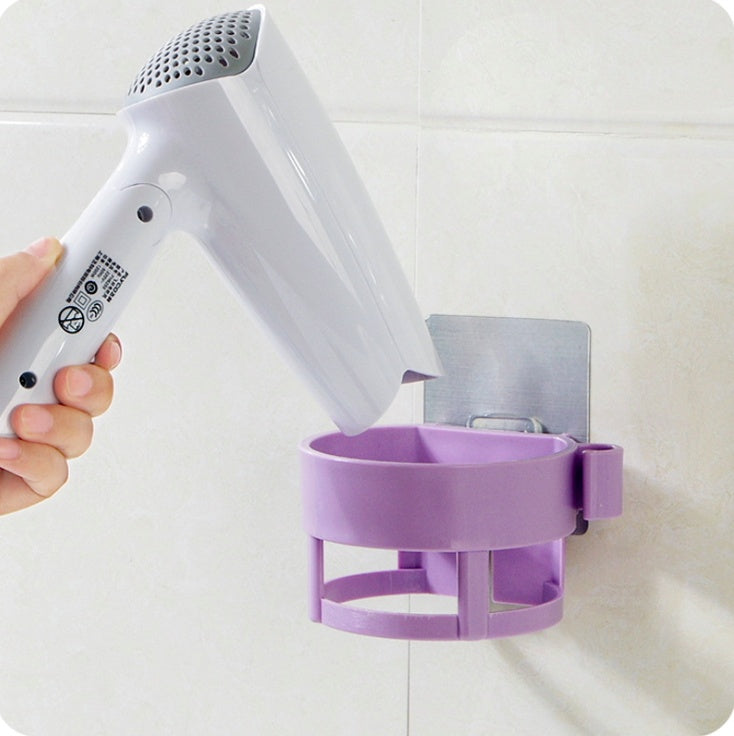 Adhesive hair dryer organiser mounted beside a bathroom vanity